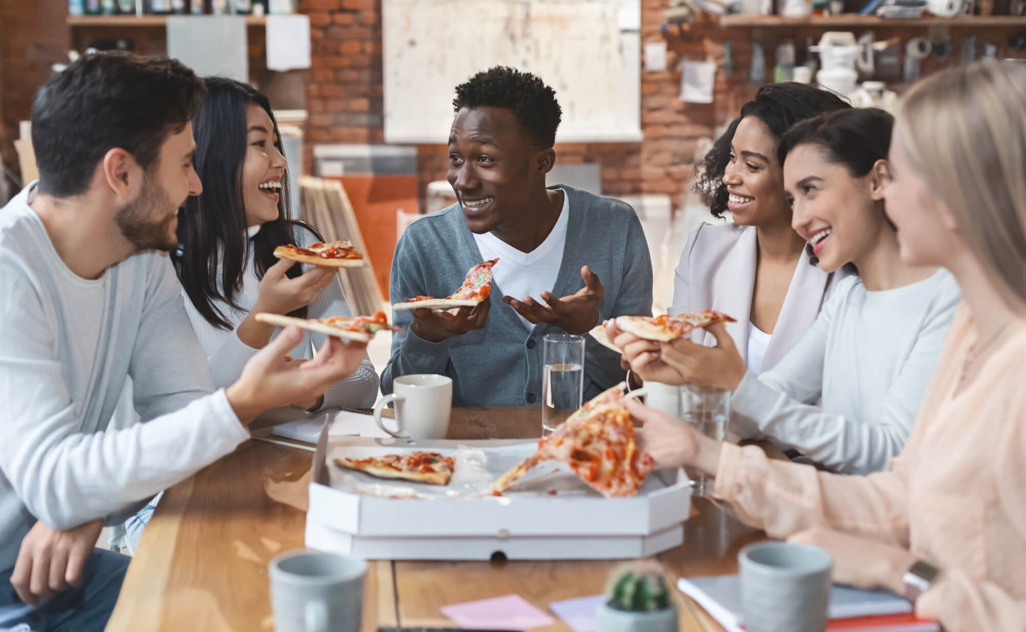 Friends enjoying pizza together.