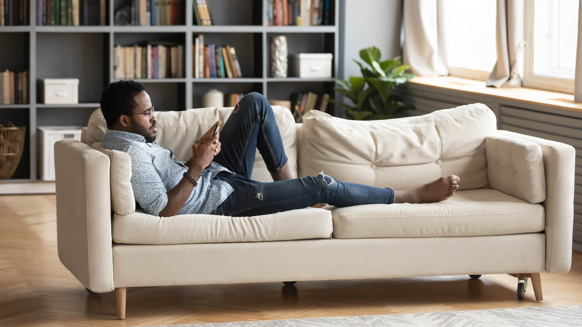Black man sitting on couch