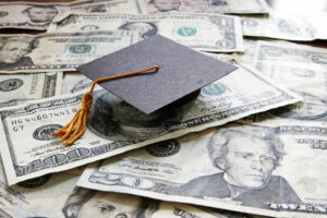 Graduation Cap on top of pile of cash
